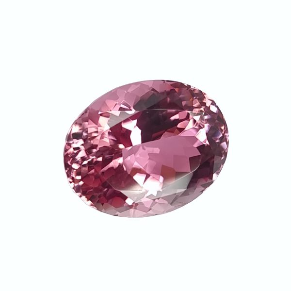 Tour 36_6 - GEMWORLD LTD Close-up of a pink faceted gemstone sphere with many angular facets against a light background