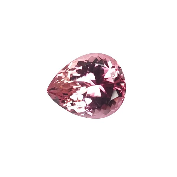 Close-up of a pink faceted gemstone with sparkling facets beneath a white background with light reflections.