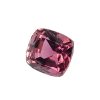 Close-up of a teardrop-shaped pink gemstone with many facets on a white background.