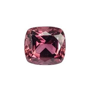 Tour 64_3 - GEMWORLD LTD Close-up of a faceted pink gemstone with a rounded rectangular cut, showing rich pink and purple facets catching light