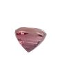 Close-up of a faceted pink gemstone with light reflecting off its many facets on a white background